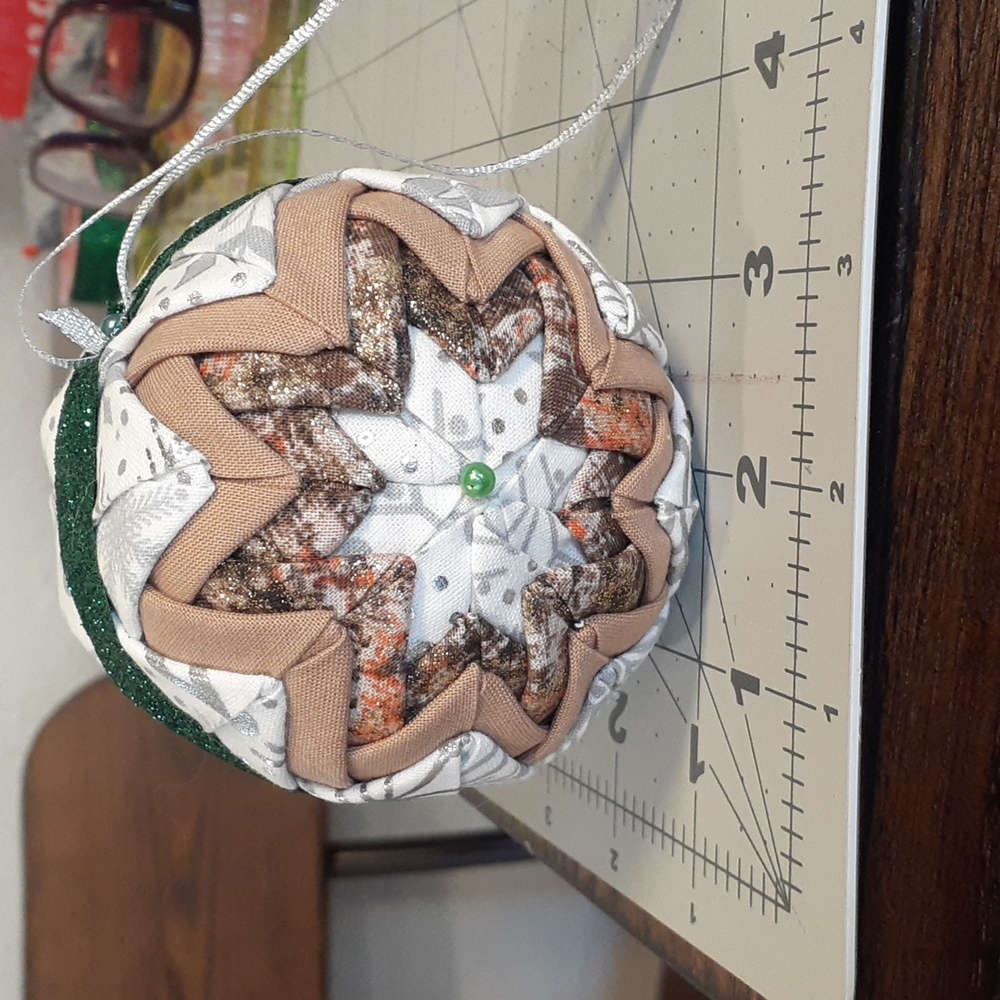 #16 Quilted Christmas Ornament. White, Tan, and Green. Approximately 3.5".